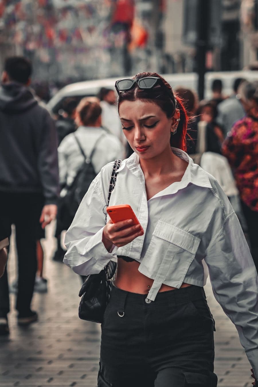 Woman on her phone in a busy street