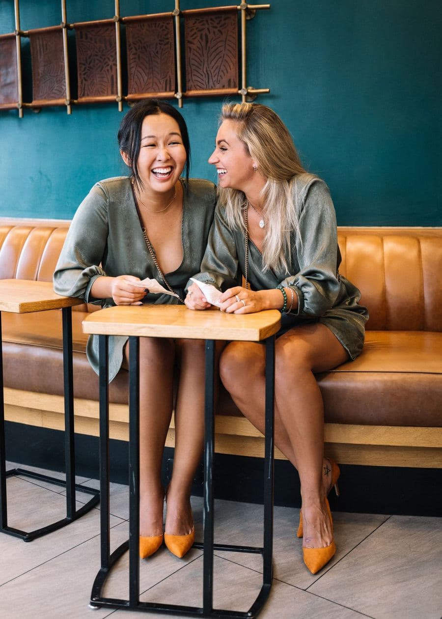 Friends sharing their phones on a couch